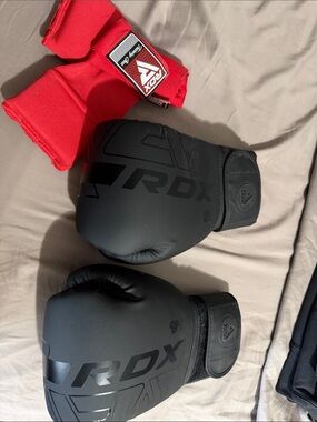 Black Boxing Gloves with Red Wrap.  Kept in good condition only tired on a few !
